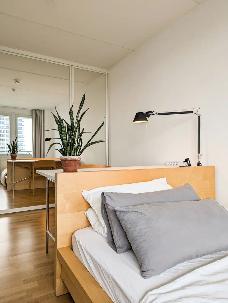 Bed with bedside lamp in the sleeping area